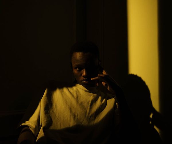 A serene person meditating in a beautifully lit room.